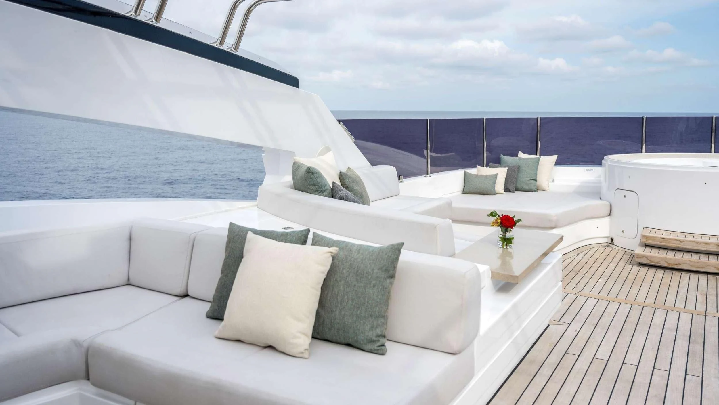 a room with a bed and a table with pillows aboard NAVIS ONE Yacht for Charter