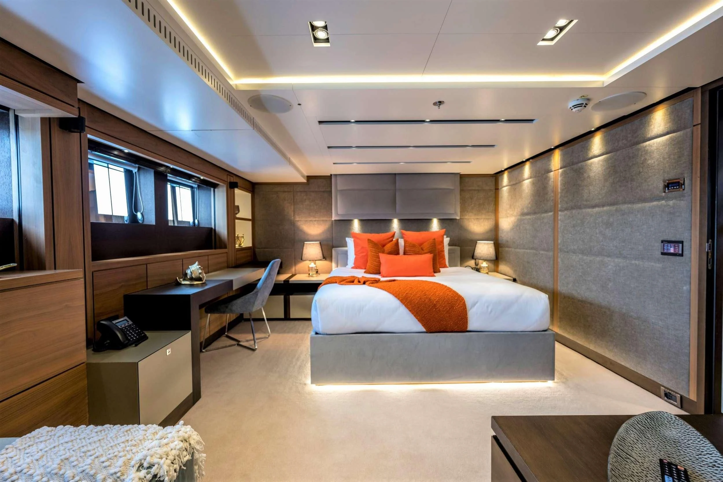 a room with a bed and a desk aboard NAVIS ONE Yacht for Charter