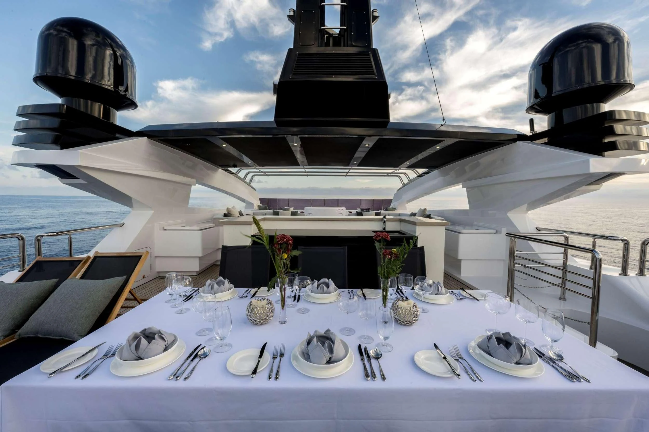 a table set for a dinner party aboard NAVIS ONE Yacht for Charter