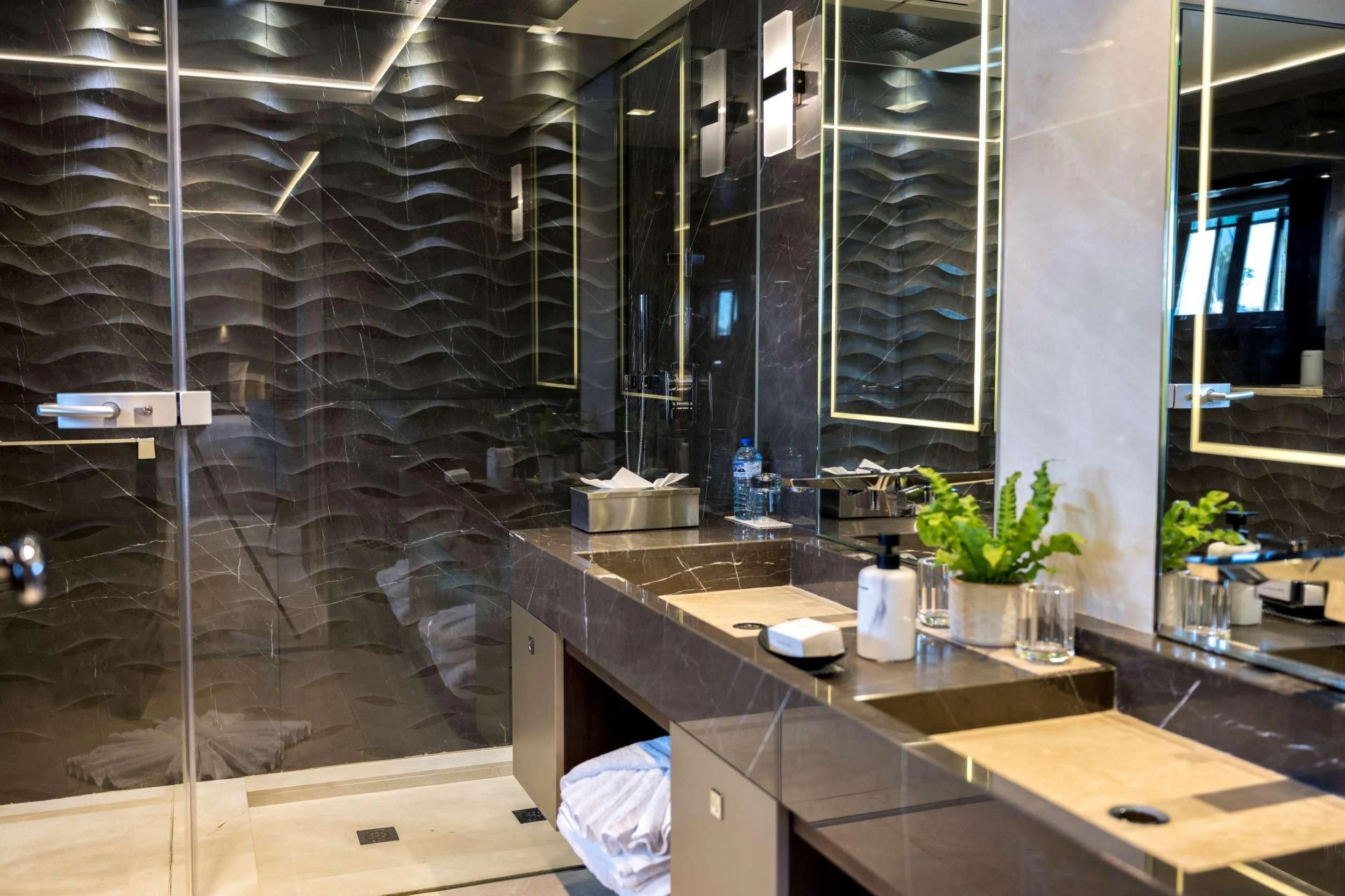 a bathroom with glass walls aboard NAVIS ONE Yacht for Charter