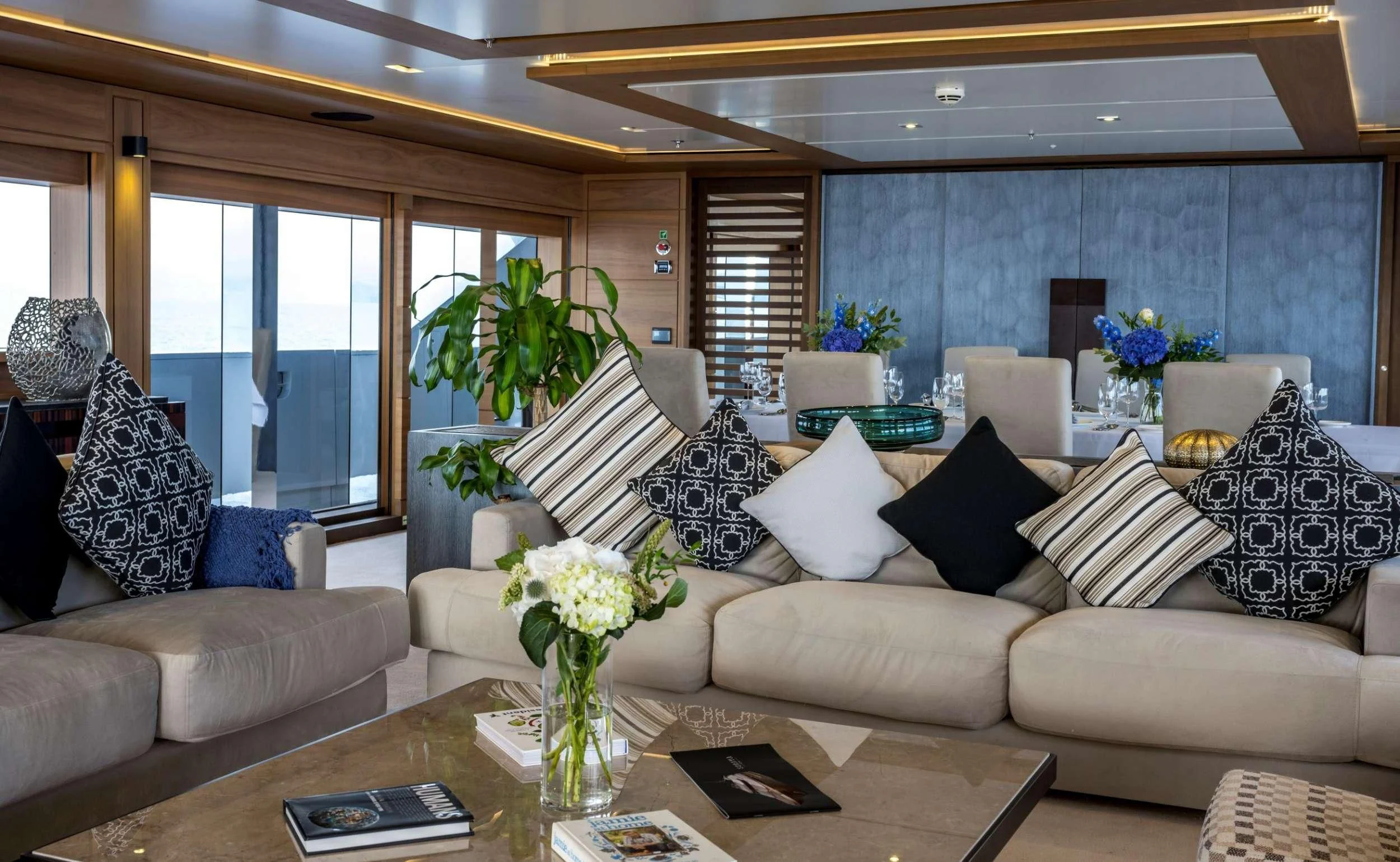 a living room with white couches and a table aboard NAVIS ONE Yacht for Charter