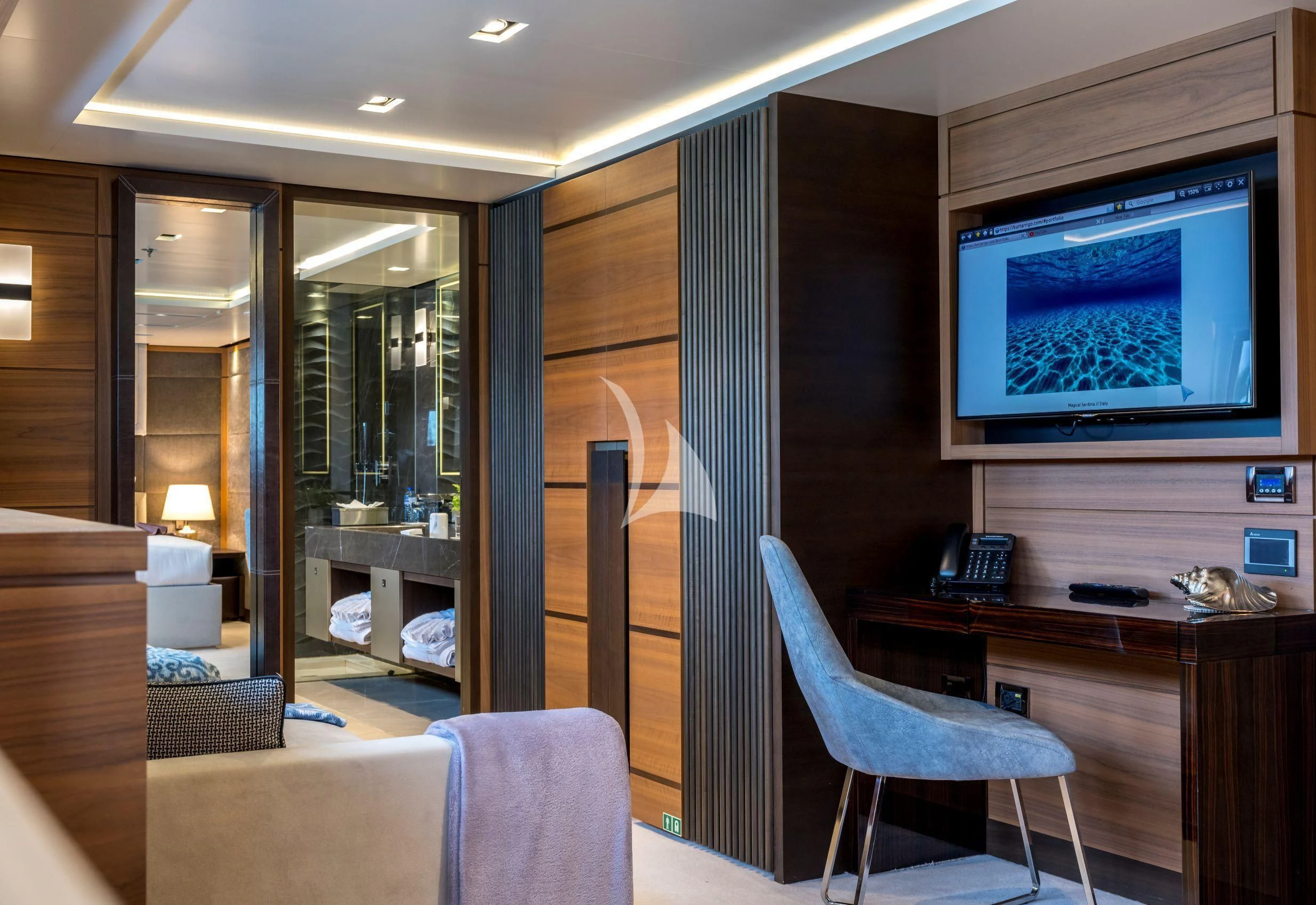 a room with a tv and a bed aboard NAVIS ONE Yacht for Charter