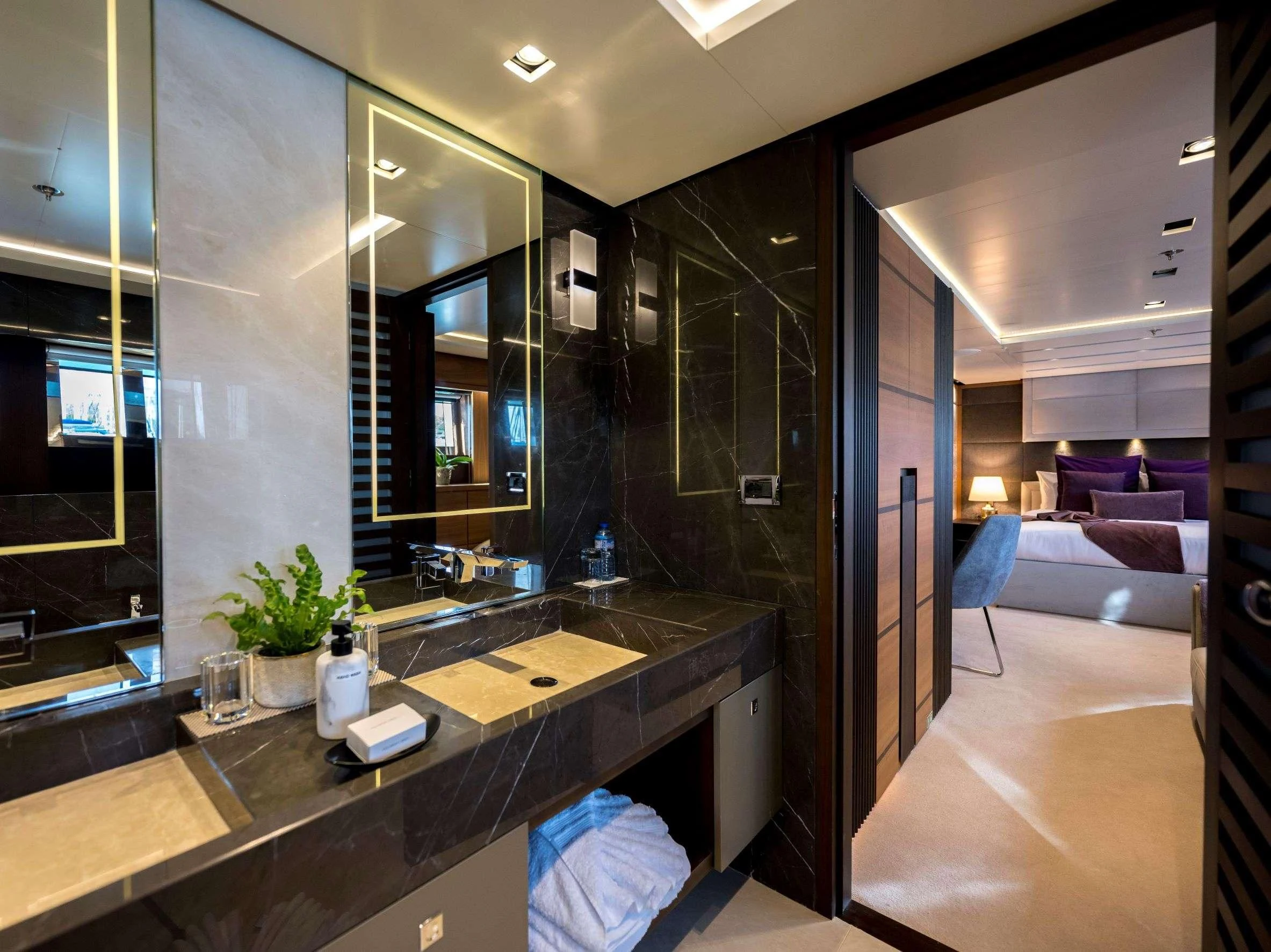 a modern bathroom with a large mirror aboard NAVIS ONE Yacht for Charter