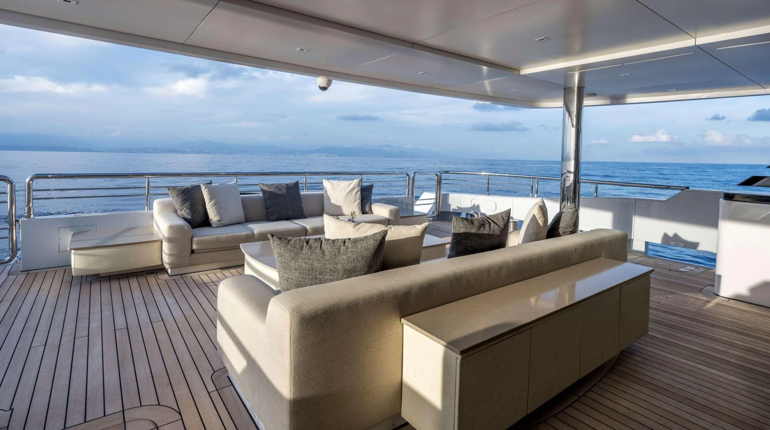 a large living room with a large balcony overlooking the ocean aboard NAVIS ONE Yacht for Charter