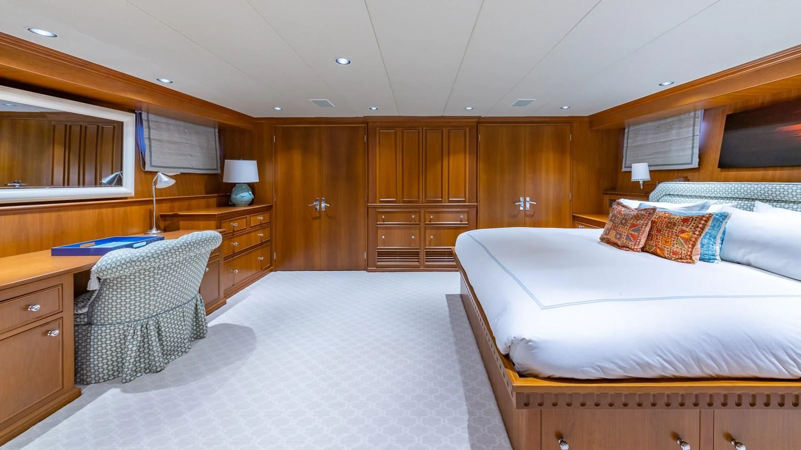 a bedroom with a bed and a chair aboard SEAQUEL Yacht for Sale