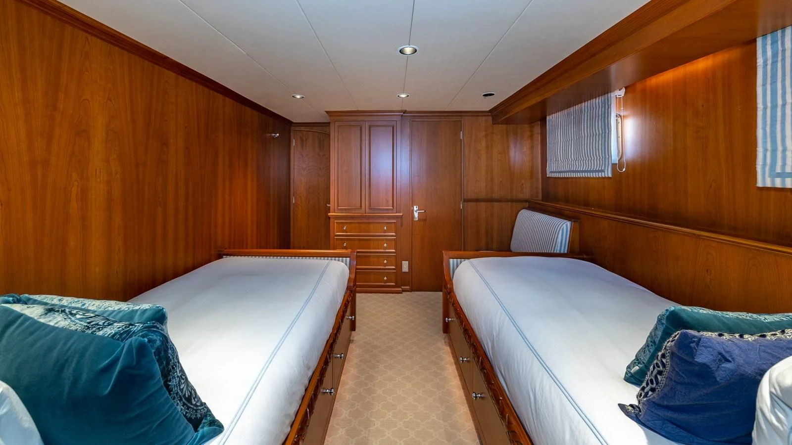 a room with wooden walls and a couple of beds aboard SEAQUEL Yacht for Sale