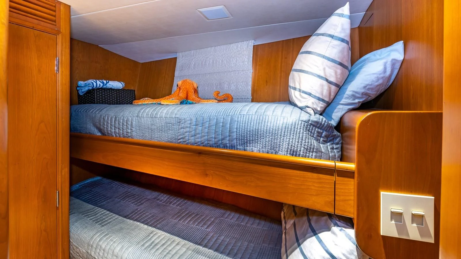 a bed with a blue sheet aboard SEAQUEL Yacht for Sale