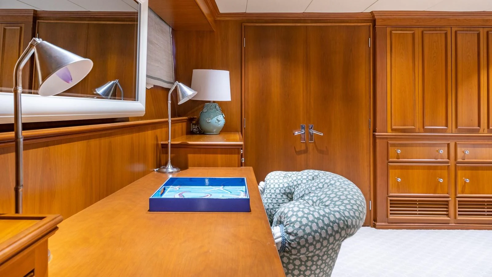 a room with a desk and a chair aboard SEAQUEL Yacht for Sale