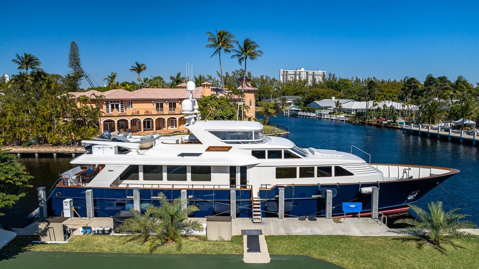 a large white boat in a harbor aboard SEAQUEL Yacht for Sale
