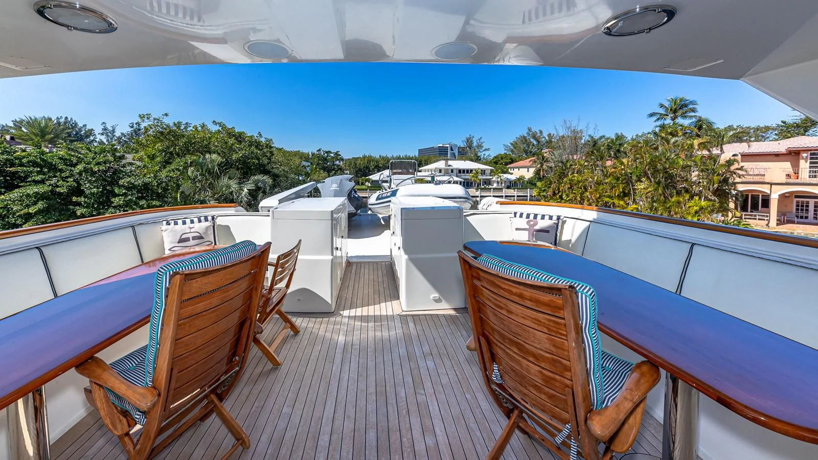 a deck with chairs and tables aboard SEAQUEL Yacht for Sale