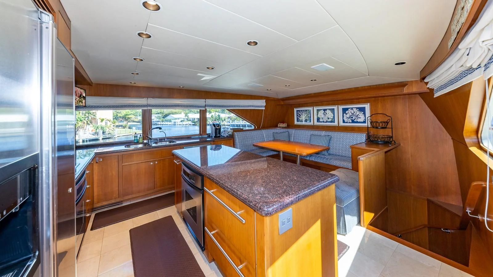 a kitchen with a bar and a table aboard SEAQUEL Yacht for Sale
