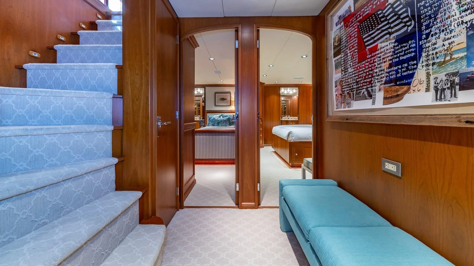a room with a bed and a blue couch aboard SEAQUEL Yacht for Sale