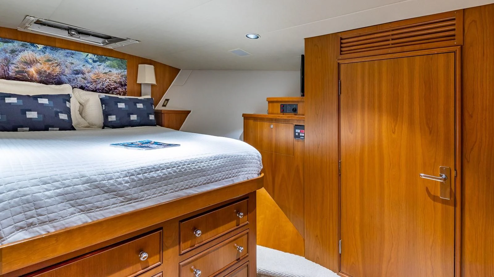 a bedroom with a bed and a desk aboard SEAQUEL Yacht for Sale