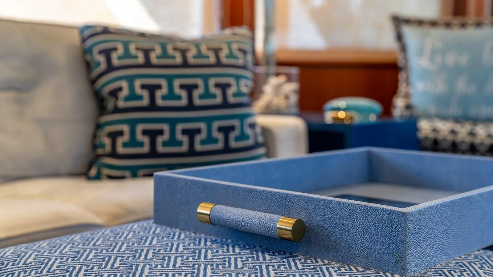 a bottle of champagne on a couch aboard SEAQUEL Yacht for Sale