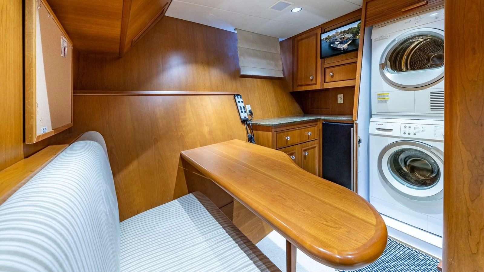 a room with a bed and a washing machine aboard SEAQUEL Yacht for Sale