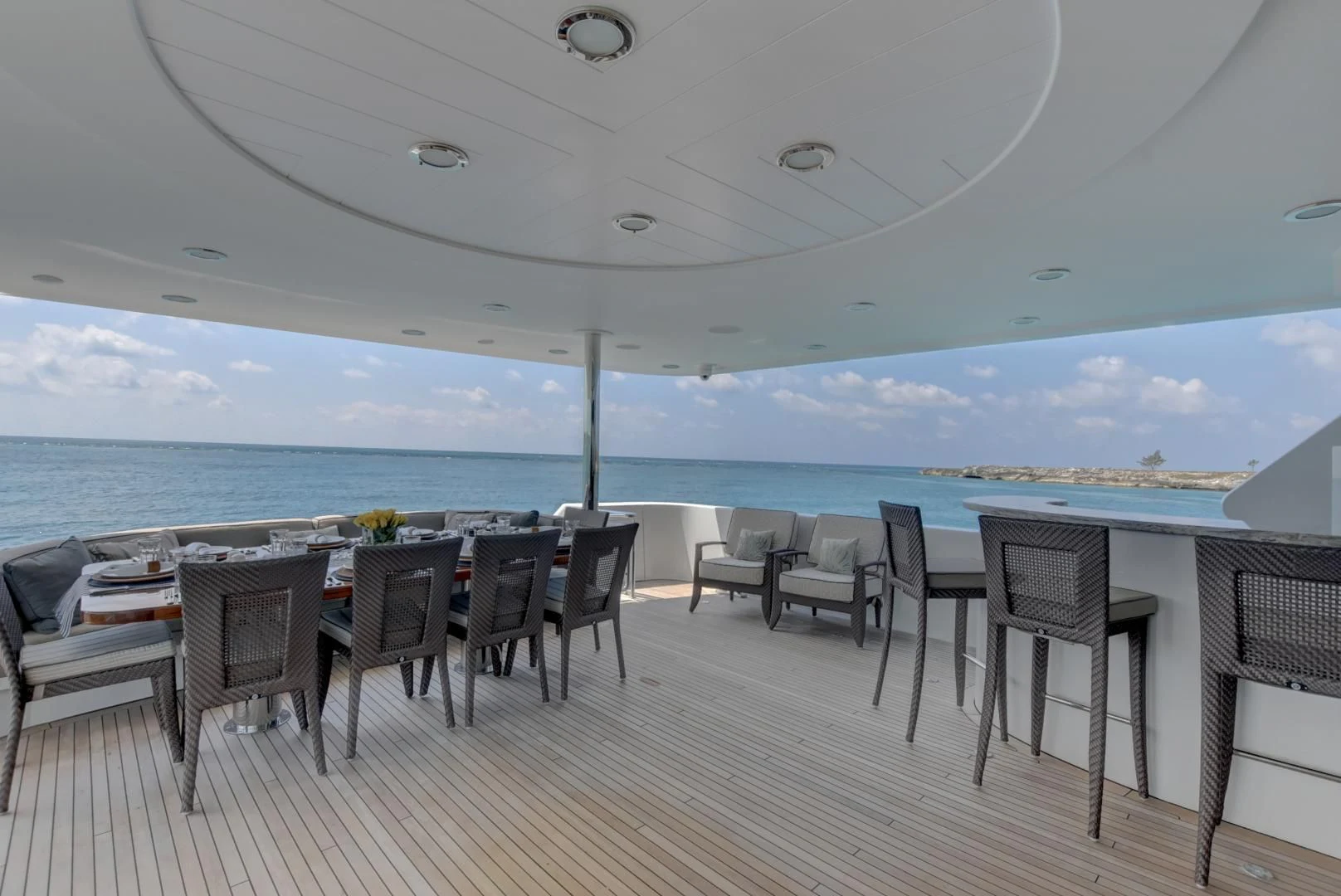 a large patio with chairs and tables aboard GOOD TIMES Yacht for Sale