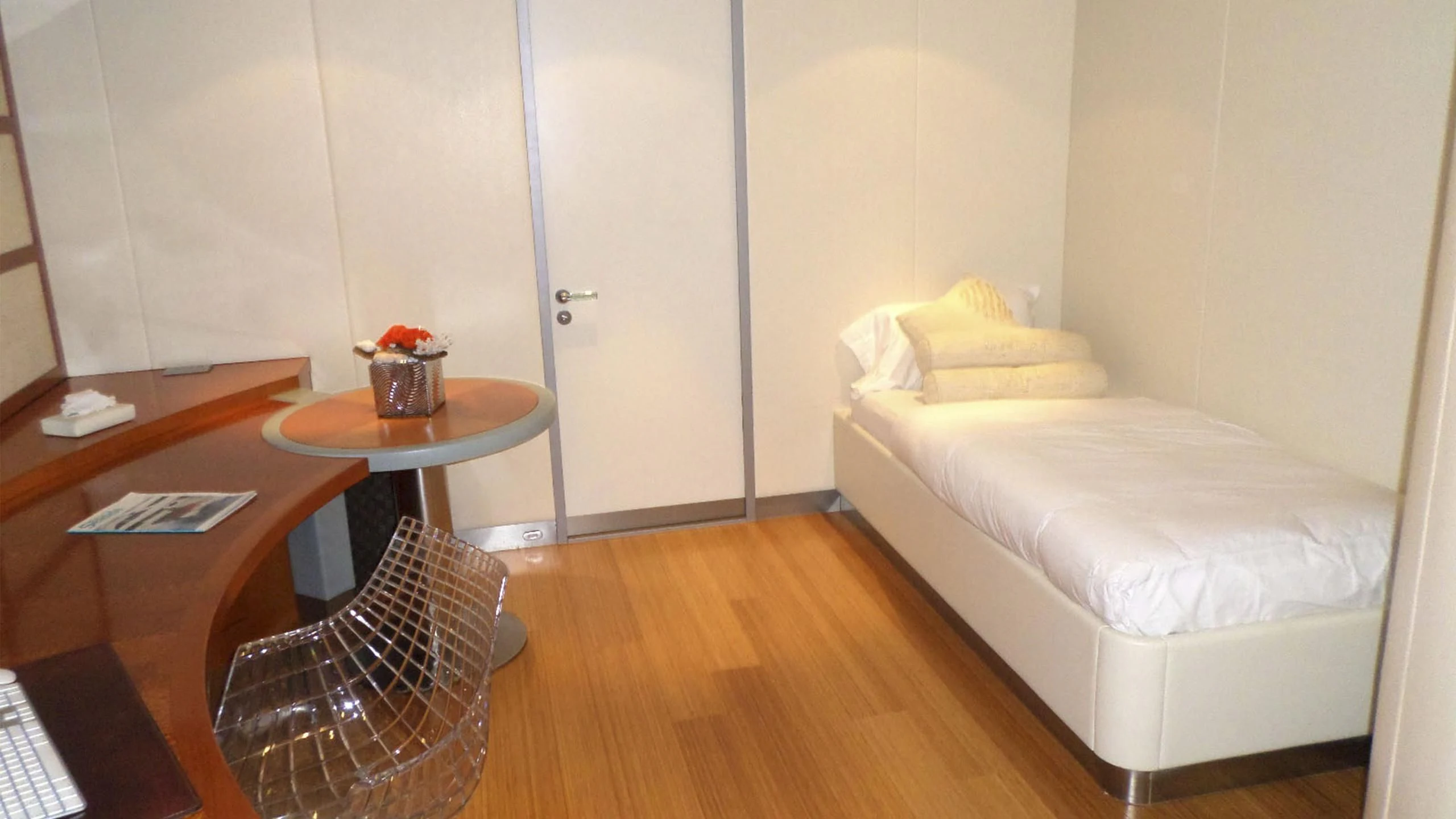 a bed and a table in a room aboard KING LOUIS Yacht for Sale