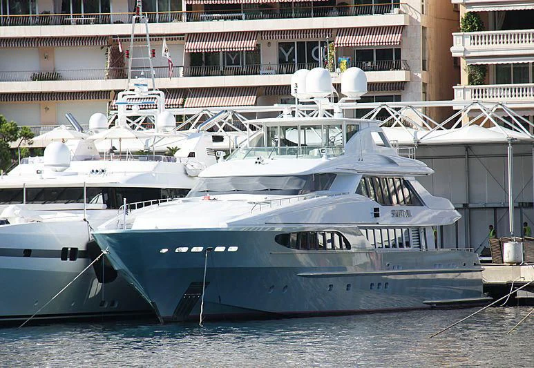 a large white boat in a harbor aboard KING LOUIS Yacht for Sale