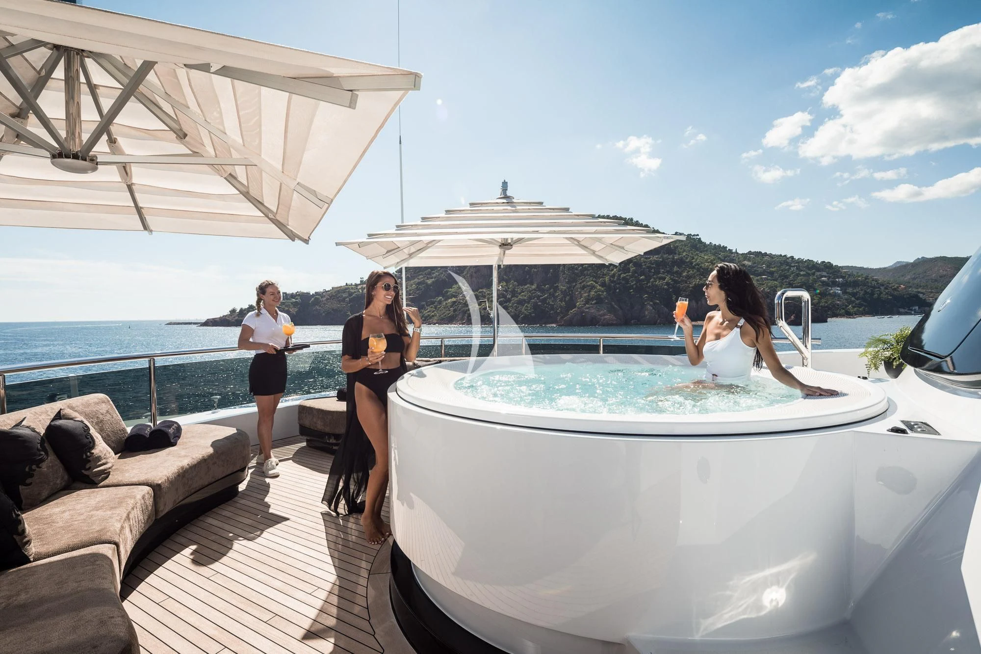 a group of people on a deck aboard TRIUMPH Yacht for Sale