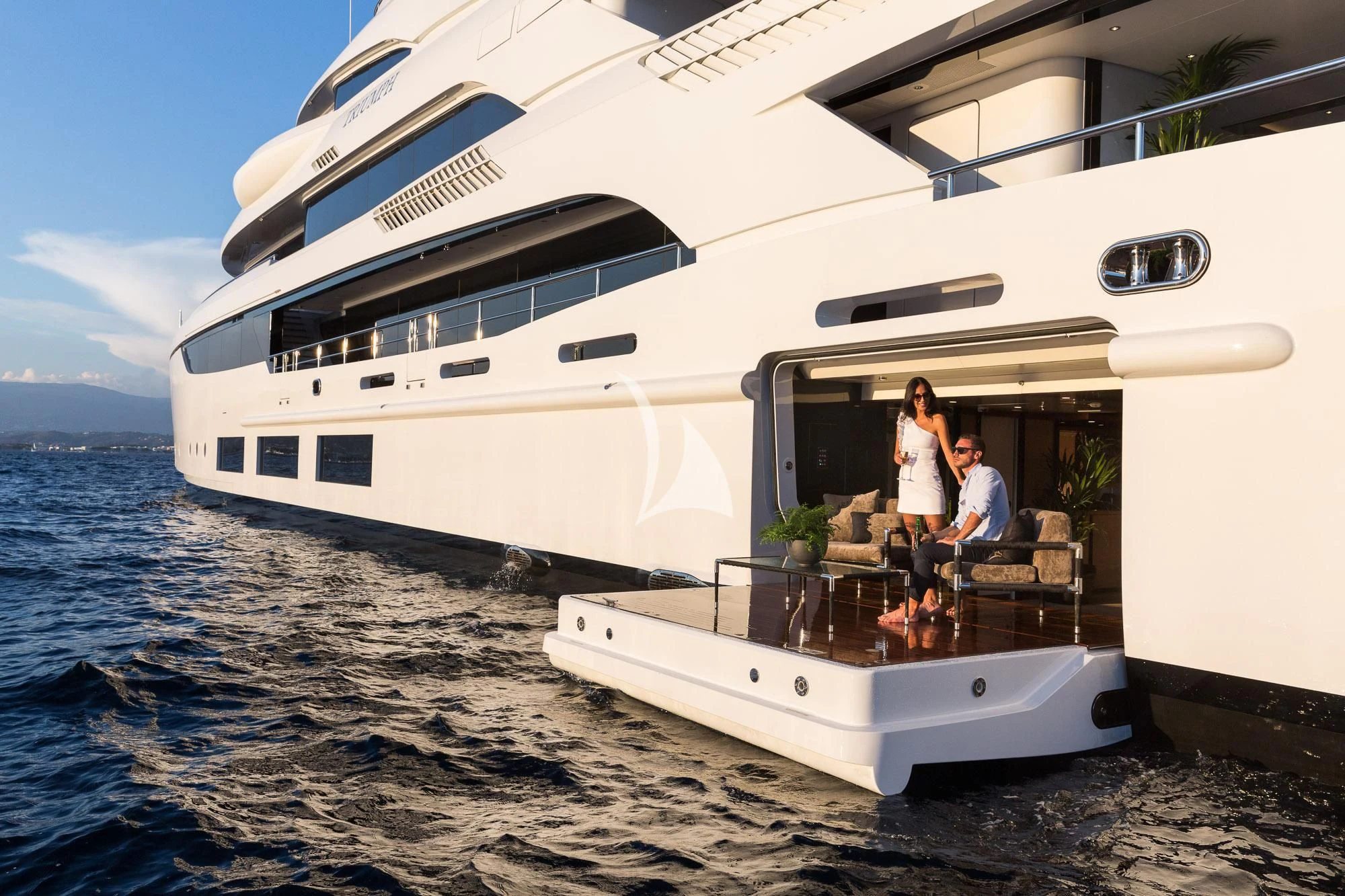 a couple sitting on a boat aboard TRIUMPH Yacht for Sale