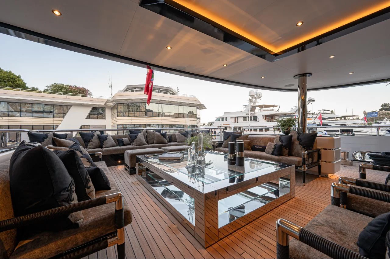 a large room with a table and chairs aboard TRIUMPH Yacht for Sale