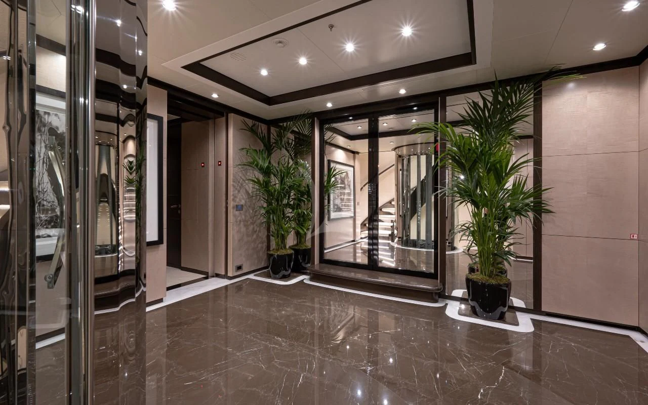 a large room with glass walls and a plant in it aboard TRIUMPH Yacht for Sale