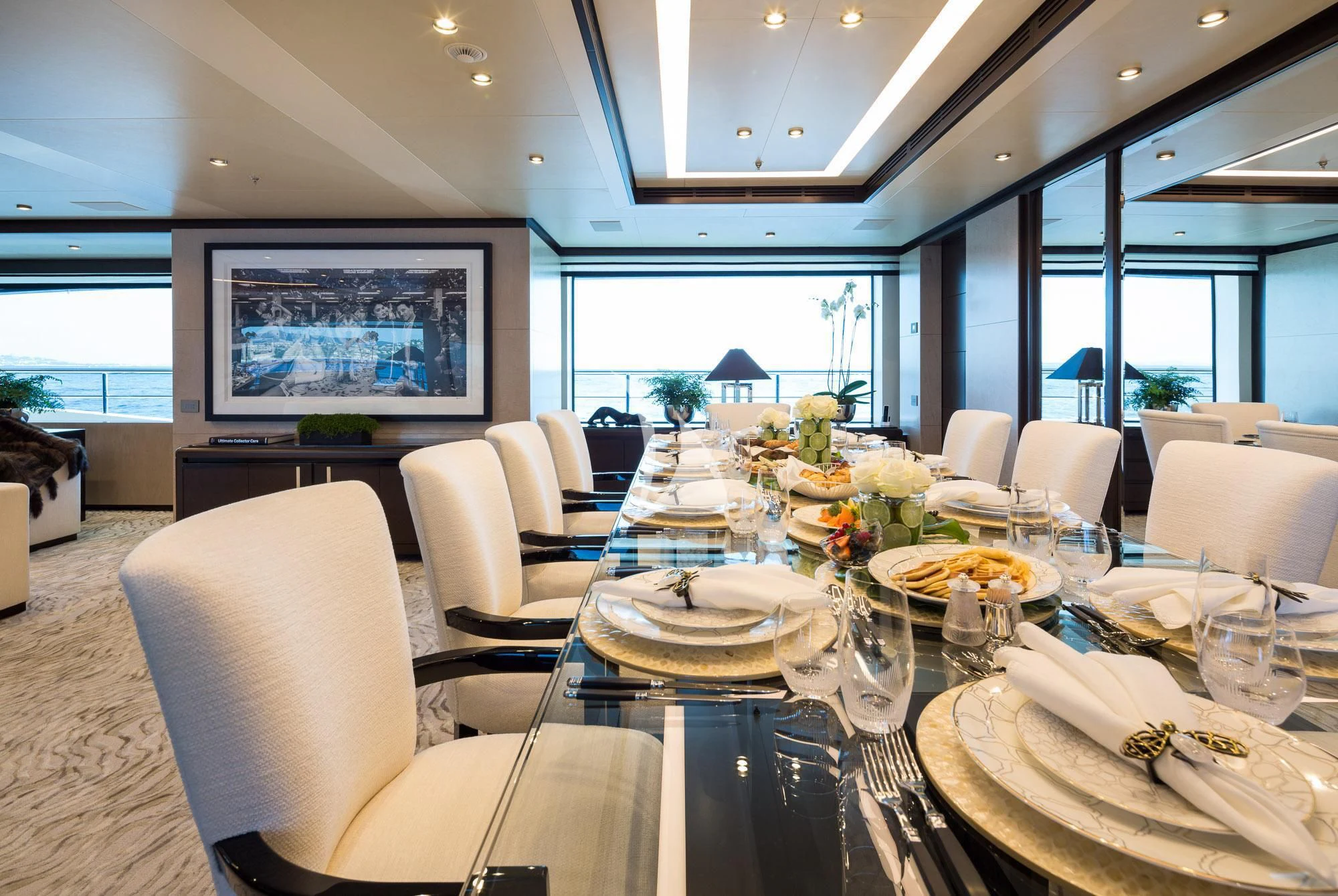 a large dining room with a large screen aboard TRIUMPH Yacht for Sale