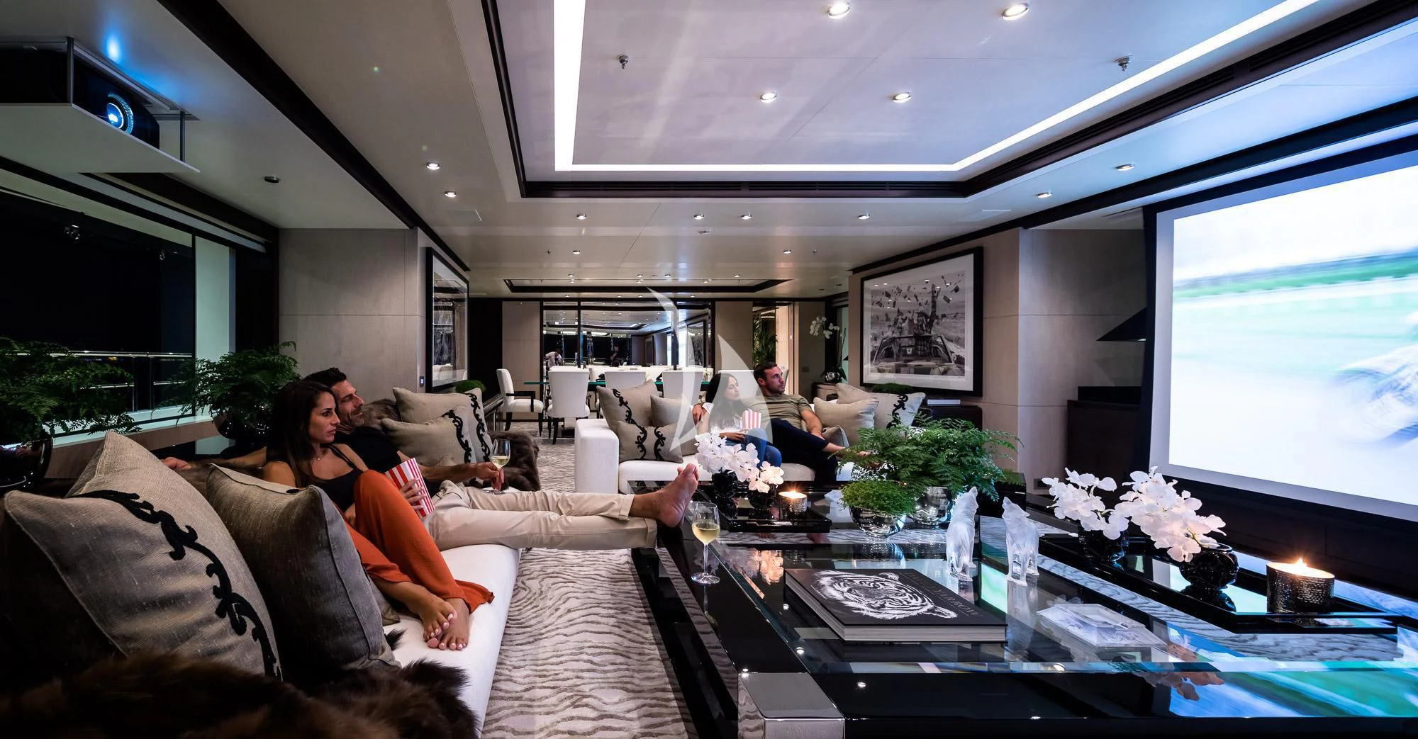 a group of people sitting in a living room aboard TRIUMPH Yacht for Sale