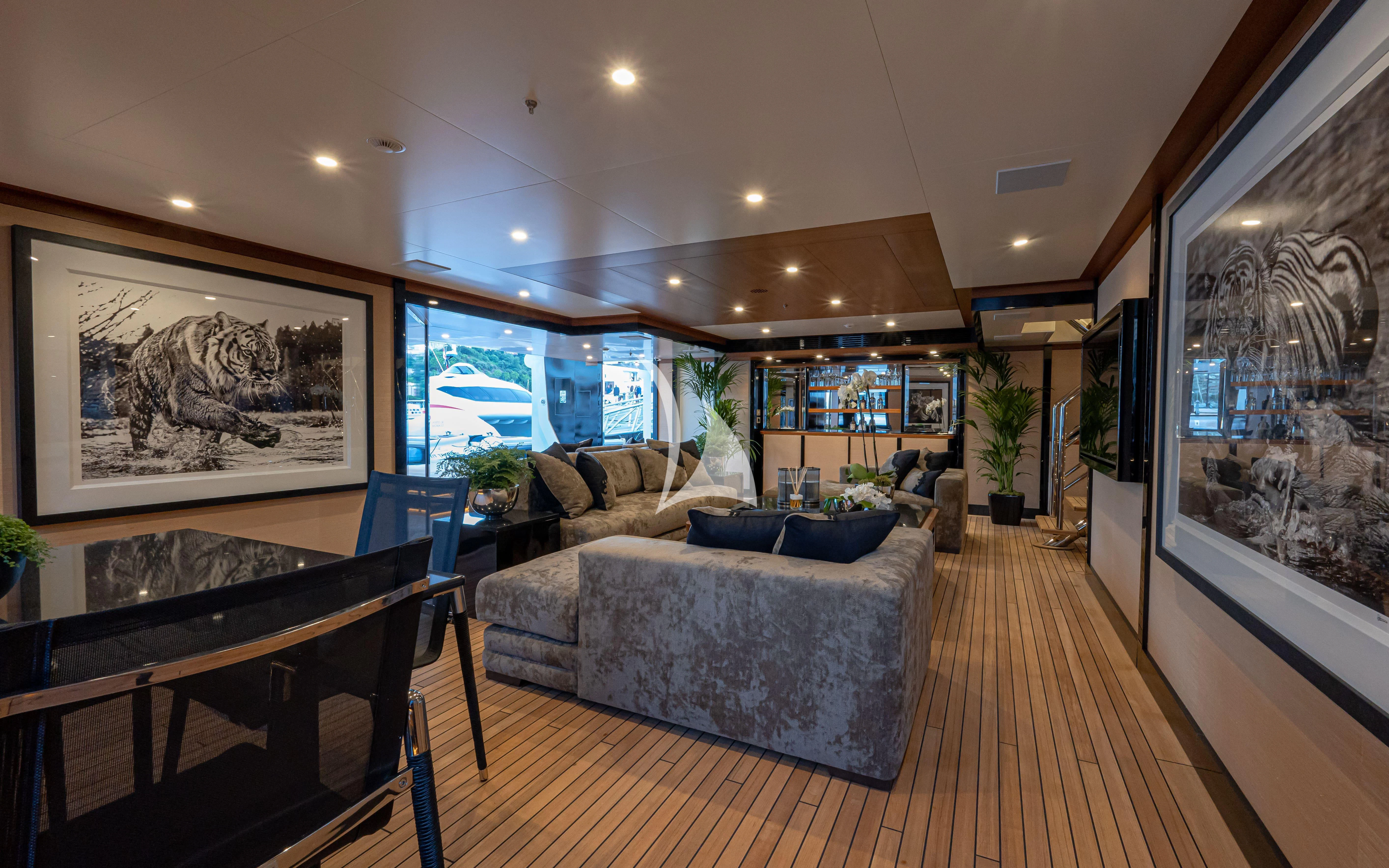 a living room with a large mirror aboard TRIUMPH Yacht for Sale