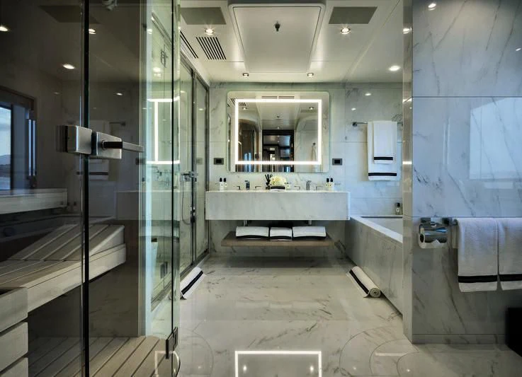 a bathroom with a tub and sinks aboard TRIUMPH Yacht for Sale