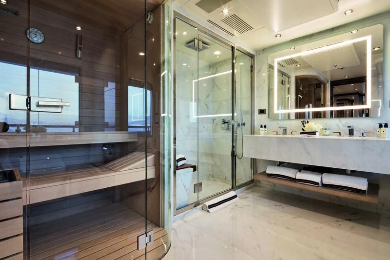 a bathroom with a glass shower aboard TRIUMPH Yacht for Sale