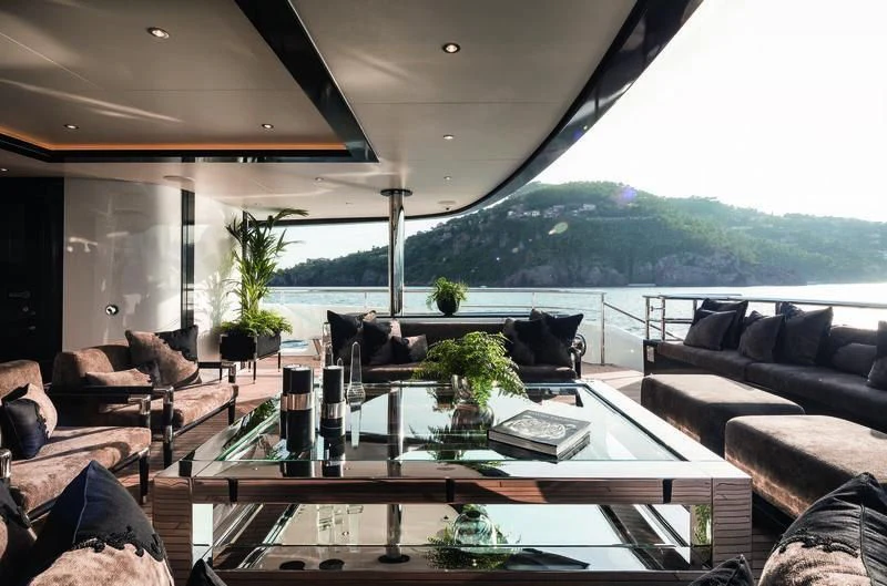 a living room with a large glass table and a large window aboard TRIUMPH Yacht for Sale