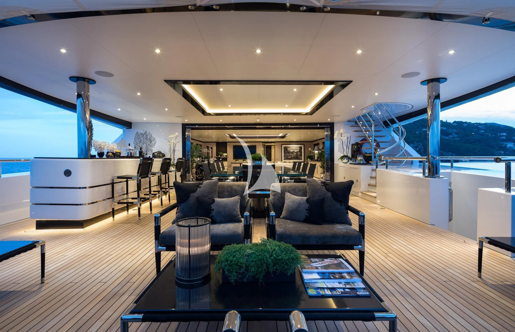 a living room with a large glass table and a couch aboard TRIUMPH Yacht for Sale