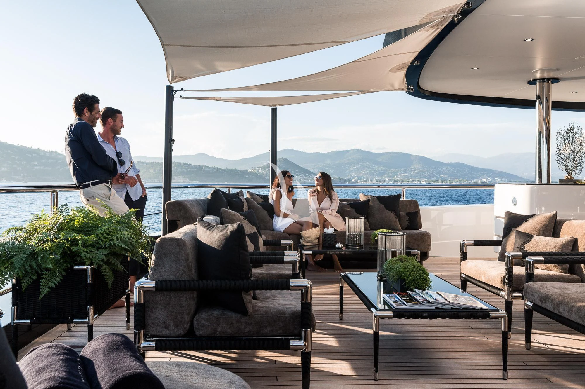 people sitting on couches aboard TRIUMPH Yacht for Sale
