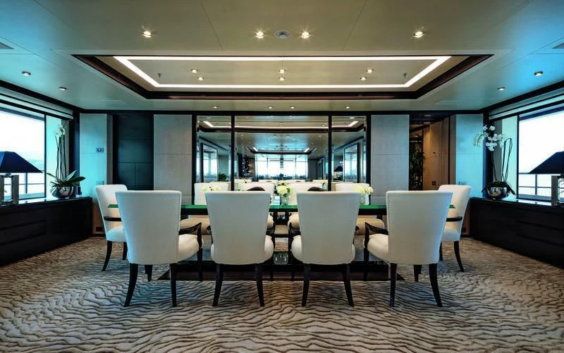 a room with a table and chairs aboard TRIUMPH Yacht for Sale