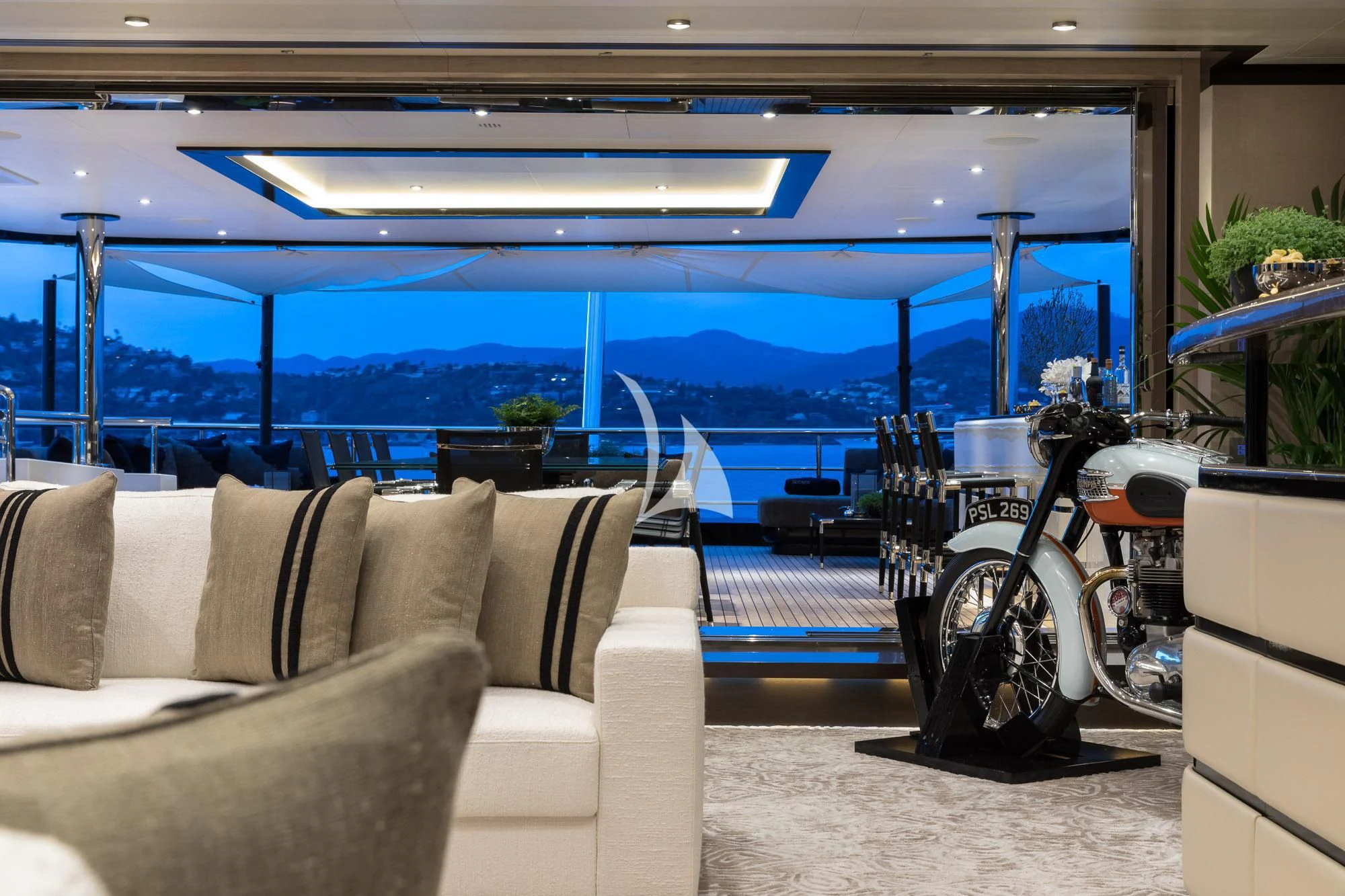 a room with a couch and a motorcycle aboard TRIUMPH Yacht for Sale