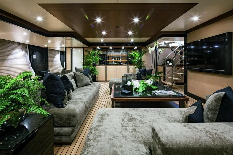 a living room with a couch and a coffee table aboard TRIUMPH Yacht for Sale