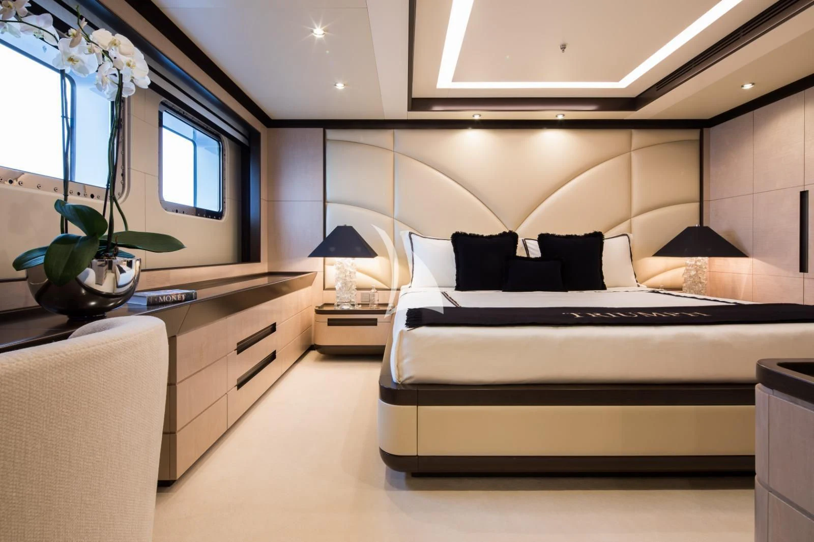 a bedroom with a bed and a desk aboard TRIUMPH Yacht for Sale