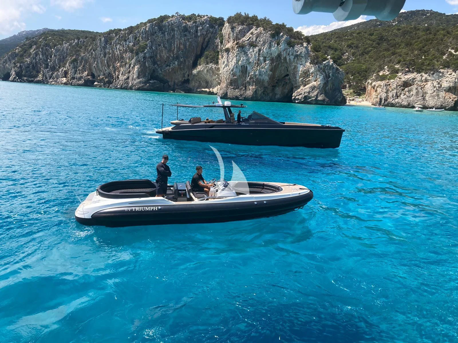 a couple of people on a boat in the water aboard TRIUMPH Yacht for Sale