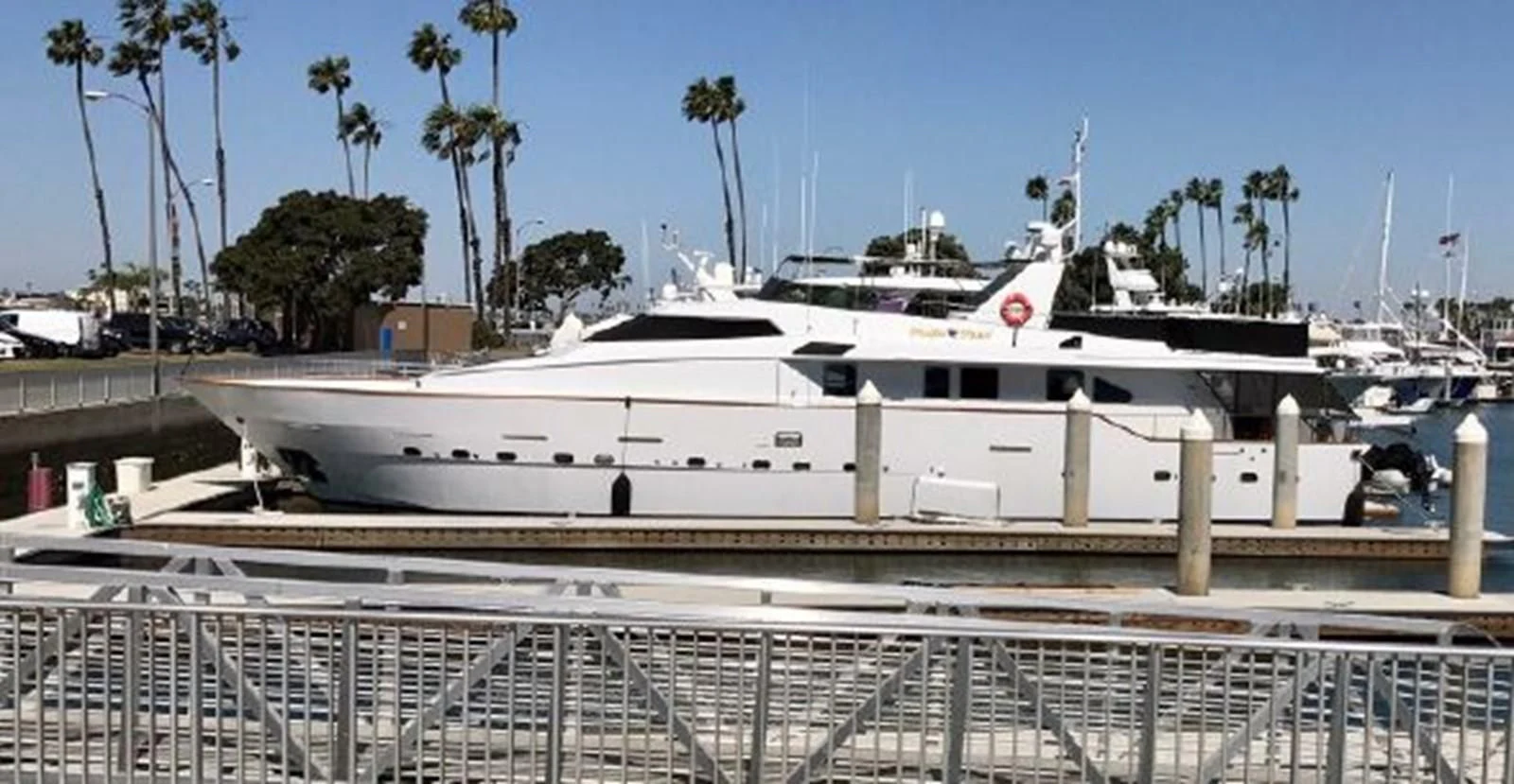 a white yacht docked at a pier aboard SILVER SPIRIT II Yacht for Sale