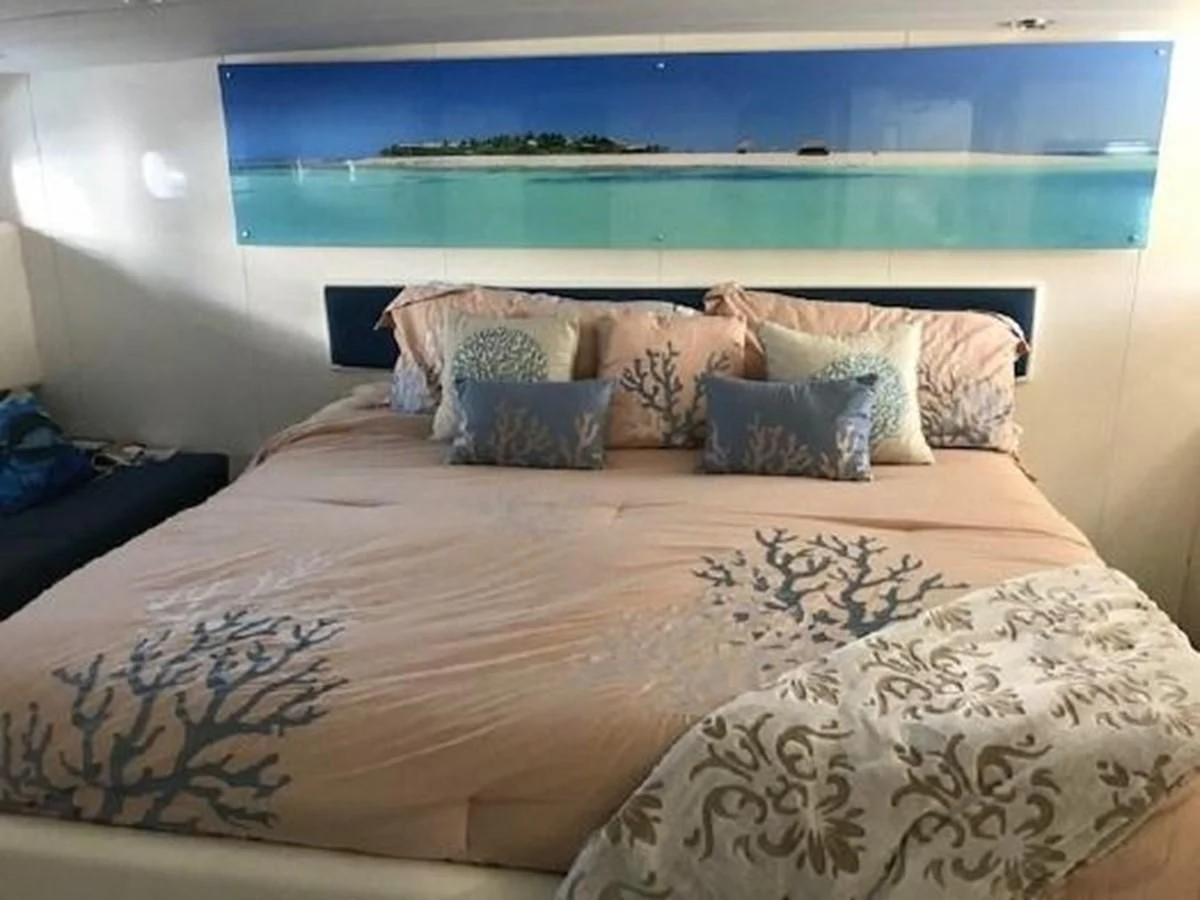 a bed with a painting on the wall aboard SILVER SPIRIT II Yacht for Sale