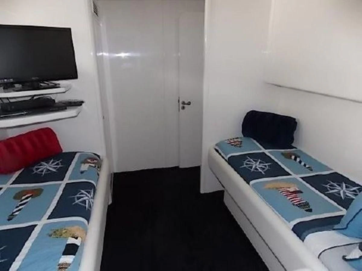 a room with a bed and a television aboard SILVER SPIRIT II Yacht for Sale