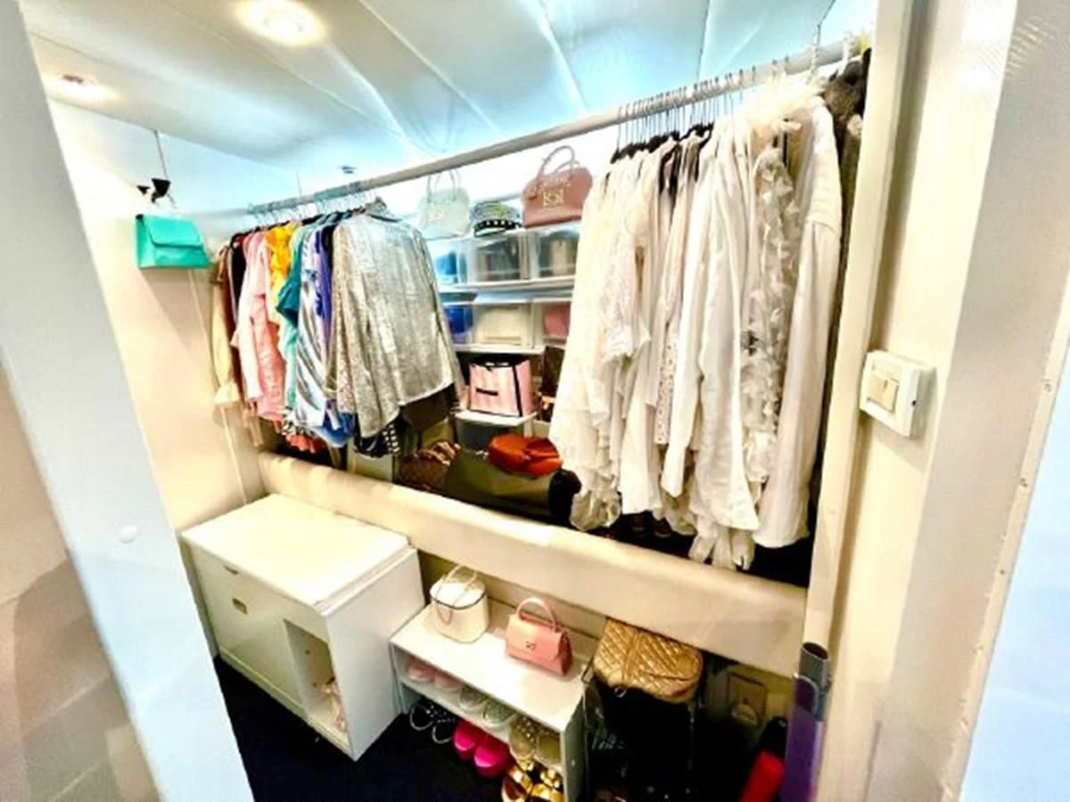 a closet with clothes on the rack aboard SILVER SPIRIT II Yacht for Sale