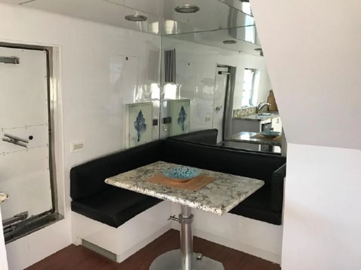 a kitchen with a table and a mirror aboard SILVER SPIRIT II Yacht for Sale