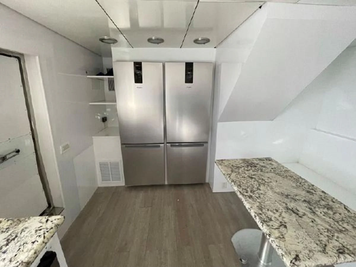 a kitchen with a fridge and a counter aboard SILVER SPIRIT II Yacht for Sale