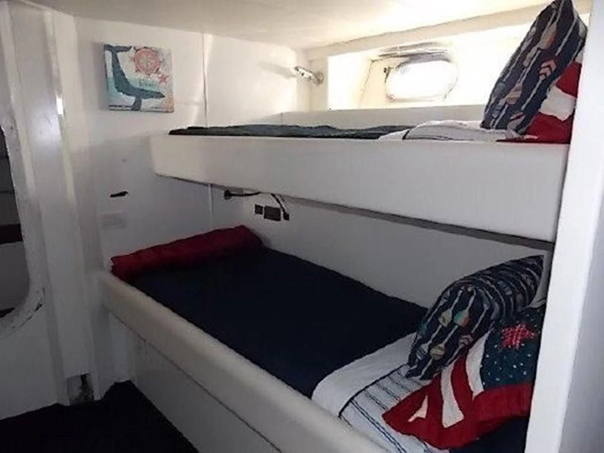 a bed with a blue sheet aboard SILVER SPIRIT II Yacht for Sale