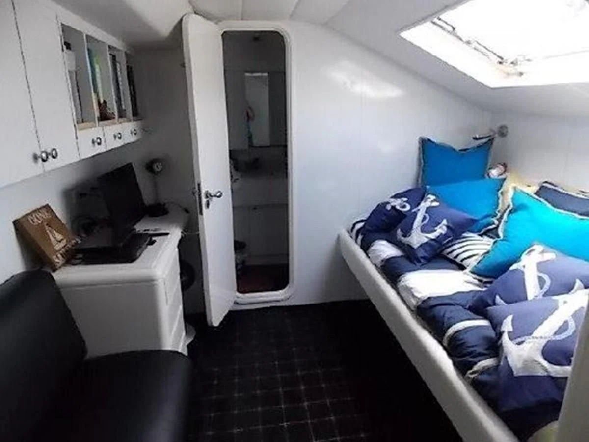 a room with a bed and a desk aboard SILVER SPIRIT II Yacht for Sale