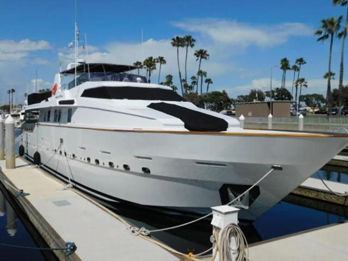 a white yacht docked at a pier aboard SILVER SPIRIT II Yacht for Sale