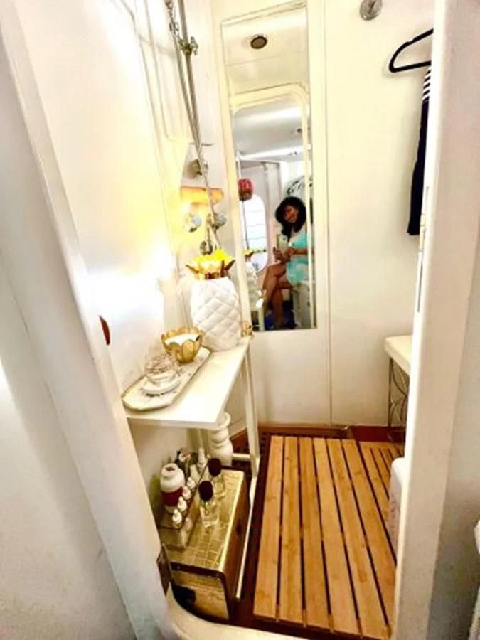 a person taking a picture of themselves in a mirror aboard SILVER SPIRIT II Yacht for Sale