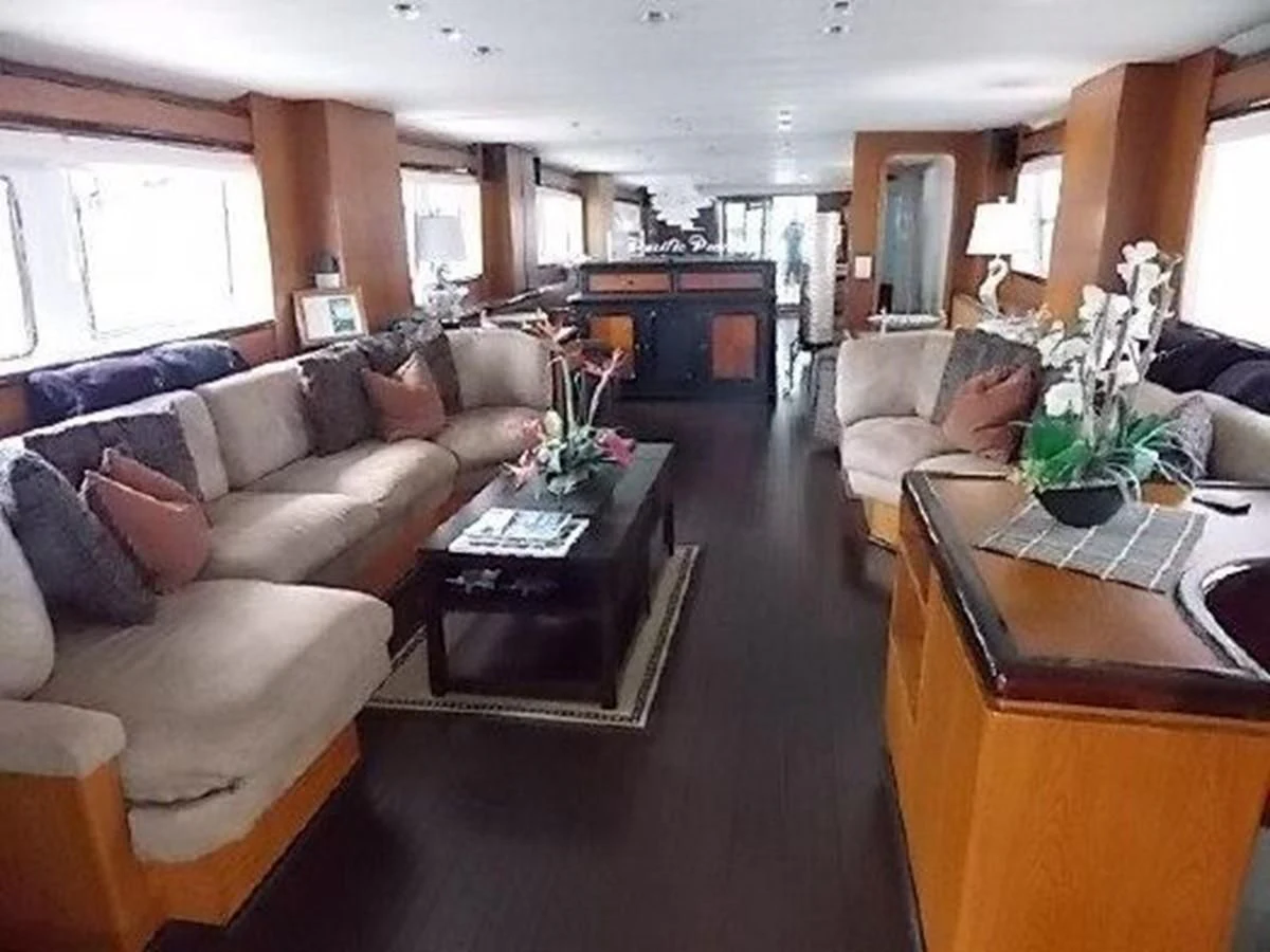 a living room with a couch and a coffee table aboard SILVER SPIRIT II Yacht for Sale